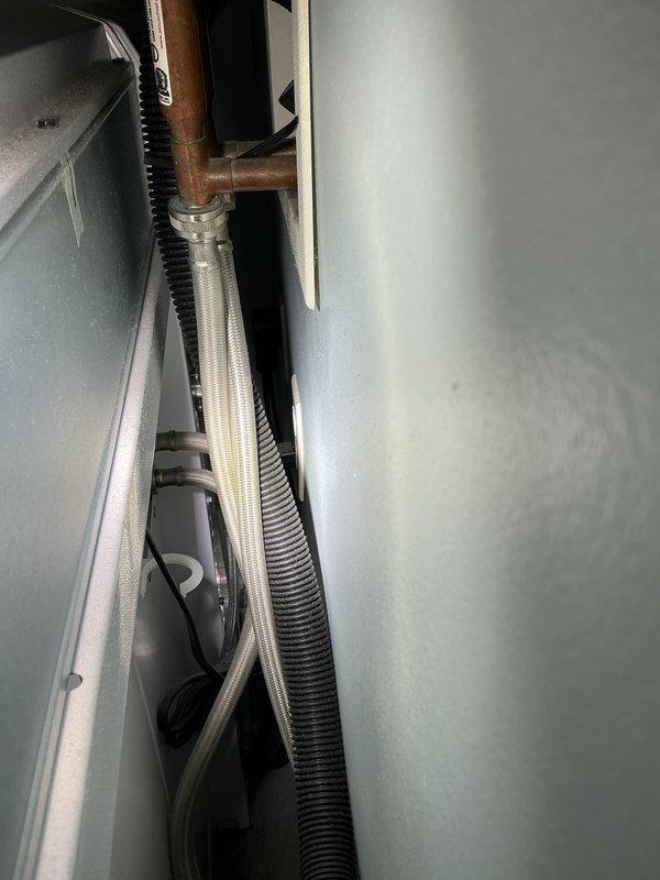 Completed plumbing membership inspection including thorough examination of under-sink plumbing assembly and HVAC utility connections. Verified proper operation of P-trap, supply lines, shut-off valves, and drainage system; confirmed all PVC connections and fittings were secure with no visible leaks. Inspected copper refrigerant lines and flexible ductwork in mechanical room area, noting normal oxidation on copper piping consistent with system age and all components functioning within normal parameters.