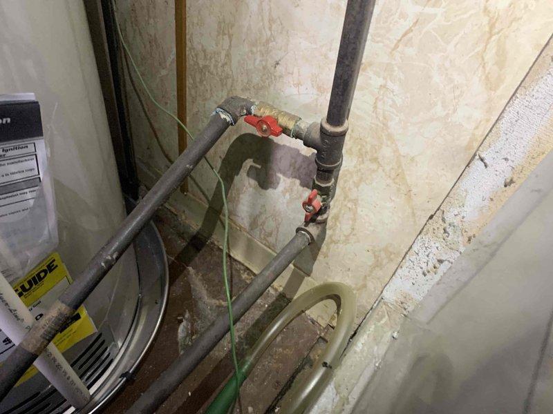Completed comprehensive tune-up on 10-year-old air conditioning system. Performed electrical diagnostics using digital multimeter, recording voltage readings at 246.0V to verify proper power supply to unit. Inspected condensate drain lines with dual ball valve shutoff configuration, checked all mechanical components, and confirmed system operational status. Unit operating within normal parameters with no immediate service needs identified.