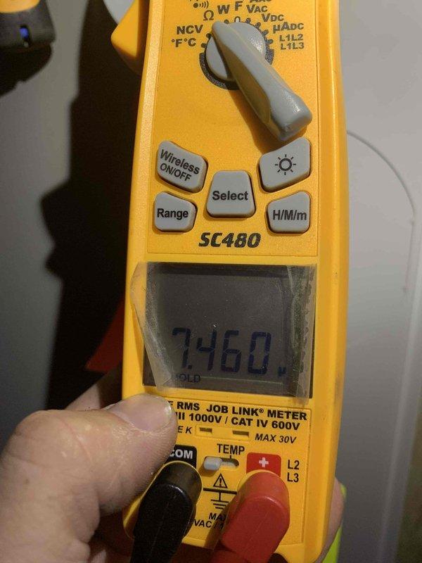 Completed comprehensive tune-up on 10-year-old air conditioning system. Performed electrical diagnostics using digital multimeter, recording voltage readings at 246.0V to verify proper power supply to unit. Inspected condensate drain lines with dual ball valve shutoff configuration, checked all mechanical components, and confirmed system operational status. Unit operating within normal parameters with no immediate service needs identified.