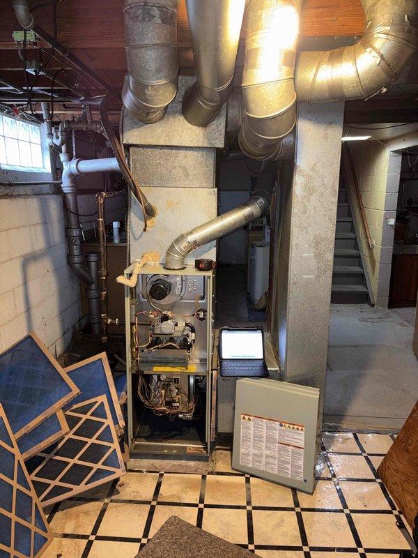 Completed HVAC system assessment for furnace replacement estimate in residential basement mechanical room. Existing furnace system evaluated with non-operational air conditioning unit, documented current equipment configuration including ductwork layout, electrical connections, and ventilation components to provide comprehensive replacement recommendations for single-unit system upgrade.