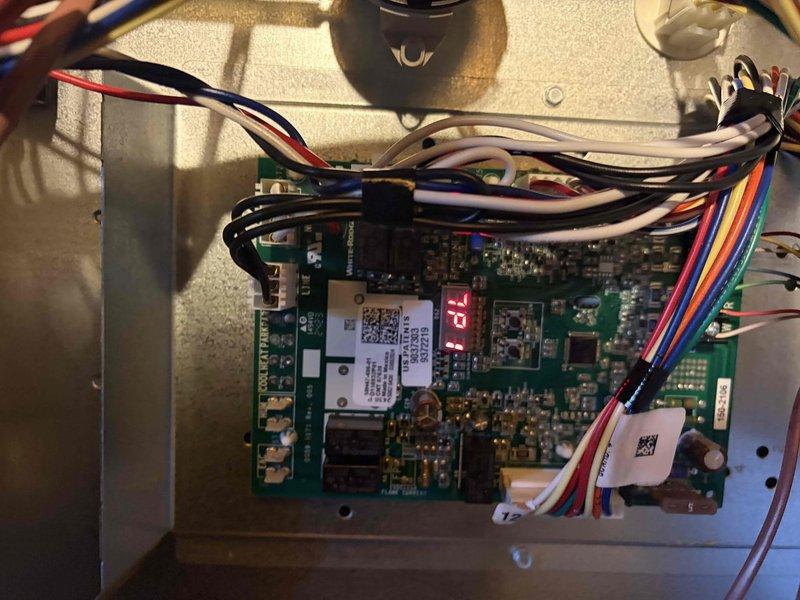 Completed cooling maintenance club visit for member with two systems experiencing insufficient heat to downstairs area. Performed comprehensive system diagnostics including inspection of control board and electrical measurements. Verified proper voltage readings at 239.2 VAC and monitored amperage draw showing 0.3A on system components. Examined thermostat control board displaying 72°F setpoint and confirmed all electrical connections and wiring harnesses were secure. Discussed ventilation concerns with homeowner regarding adding two additional supply vents to air handler to improve downstairs airflow and heat distribution.