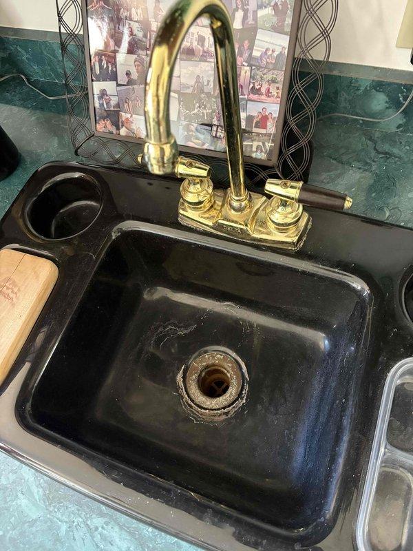 Responded to call for toilet leaking at floor connection during flushing after extended period of non-use. Upon inspection, identified corroded and deteriorated shut-off valve assembly with significant mineral buildup and water damage. Replaced faulty valve hardware and water supply line, ensuring proper seal at floor flange connection. Tested flush mechanism multiple times to verify leak was resolved and all connections remained watertight under operating pressure.