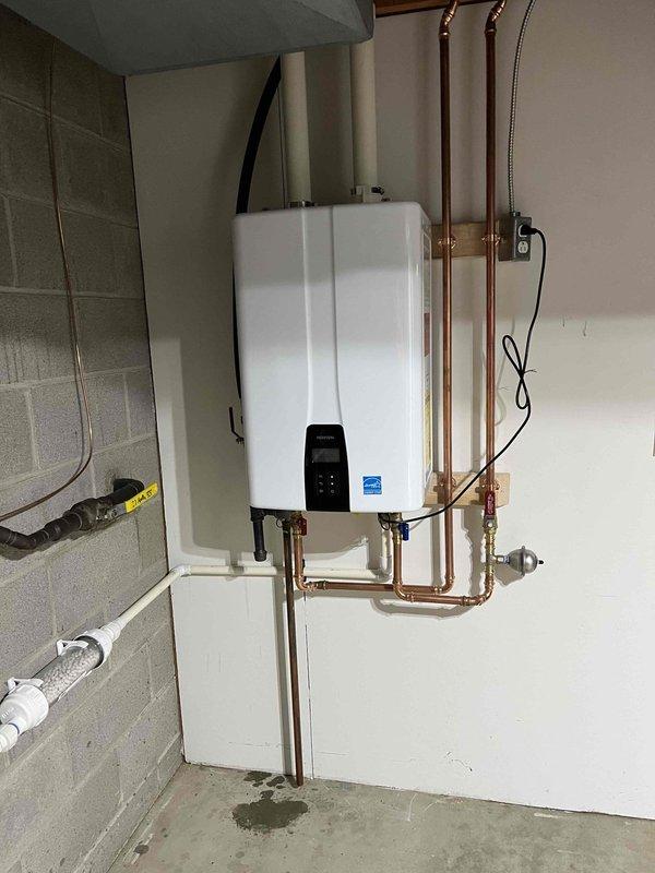 Installed under-sink water filtration system in kitchen and replaced existing kitchen faucet. Completed installation of tankless water heater with copper supply lines, proper venting, and electrical connections, including wall-mounted monitoring sensor with indicator light.