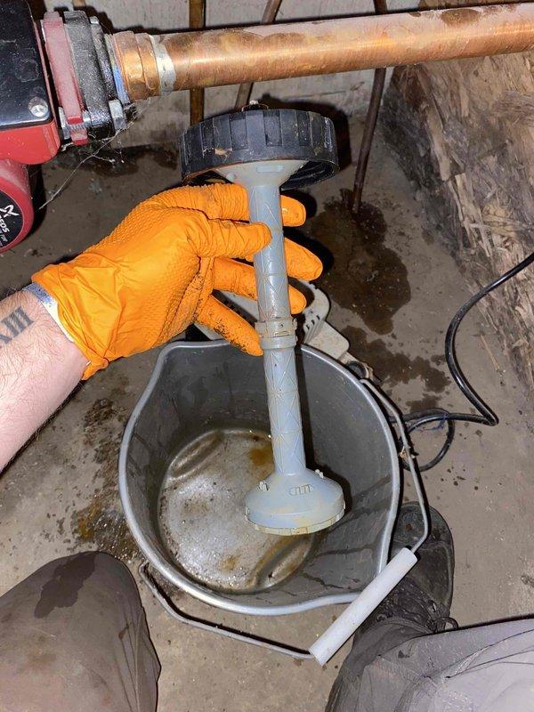 Responded to service call for boiler making noises when reaching operating temperature. Upon inspection, discovered failed condensate pump with significant corrosion on pump mechanism and sediment accumulation in collection basin. Removed and replaced defective condensate pump unit. Cleared drain lines and tested system operation through complete heating cycle to verify proper condensate removal and confirm noise issue was resolved.