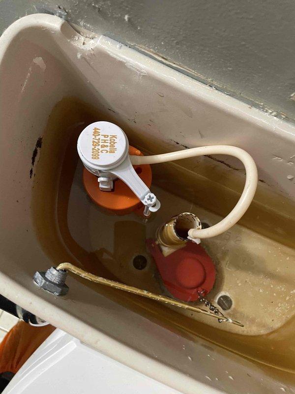 Responded to complaint of toilet continuing to run after homeowner installed new flapper. Upon inspection, found significant mineral buildup and discolored water throughout tank interior, indicating water quality issues and aged components in 20-year-old home. Diagnosed that fill valve assembly was malfunctioning due to mineral deposits interfering with float mechanism operation, preventing proper shutoff. Replaced fill valve assembly and adjusted water level to manufacturer specifications. Cleaned mineral deposits from tank interior and flush valve seat to ensure proper flapper seal. Tested flush cycle multiple times to verify complete shutoff and proper refill operation. System now functioning correctly with no continuous running.