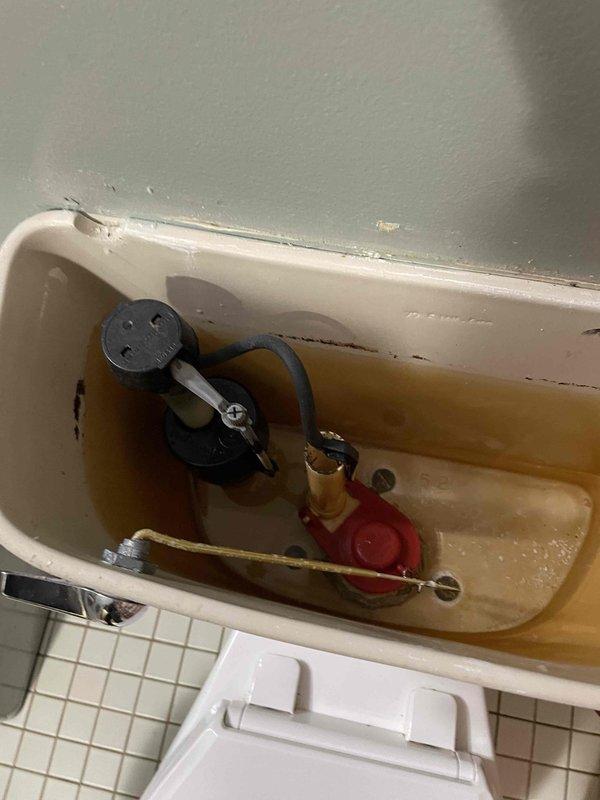 Responded to complaint of toilet continuing to run after homeowner installed new flapper. Upon inspection, found significant mineral buildup and discolored water throughout tank interior, indicating water quality issues and aged components in 20-year-old home. Diagnosed that fill valve assembly was malfunctioning due to mineral deposits interfering with float mechanism operation, preventing proper shutoff. Replaced fill valve assembly and adjusted water level to manufacturer specifications. Cleaned mineral deposits from tank interior and flush valve seat to ensure proper flapper seal. Tested flush cycle multiple times to verify complete shutoff and proper refill operation. System now functioning correctly with no continuous running.