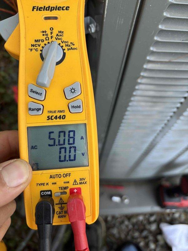 Completed routine AC tune-up on four-year-old cooling system. Performed standard maintenance procedures including electrical measurements using clamp meter, recording amperage draw of 5.08A and voltage readings on outdoor unit. Inspected condenser coil fins and overall system operation, confirming equipment is functioning within normal parameters.