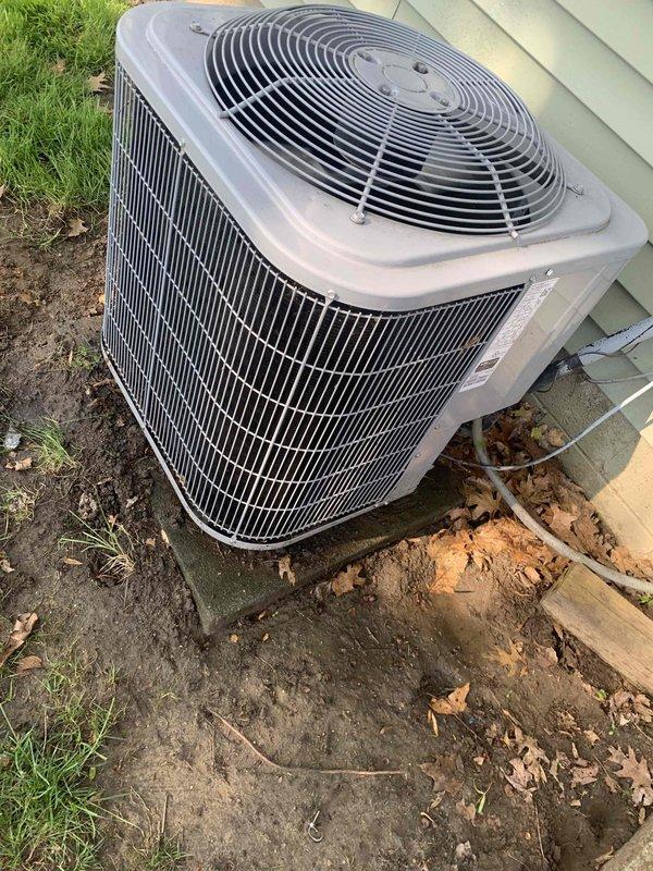 Performed routine AC tune-up on residential outdoor condensing unit. Cleared accumulated leaves and debris from around unit base and exterior grilles, inspected electrical connections, verified proper airflow through coil fins, and confirmed unit operational status. System operating within normal parameters upon completion of maintenance visit.