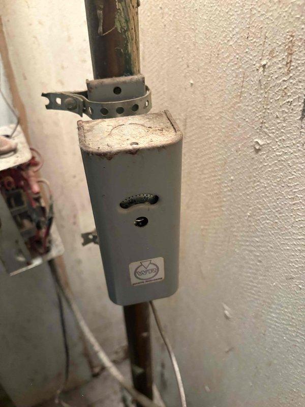 Responded to service call for non-operational 1978 boiler system. Upon inspection, confirmed complete failure of existing boiler unit requiring full replacement. Documented existing installation including wall-mounted components, piping configuration, electrical junction box with wire connections, and overall mechanical room setup. Prepared comprehensive replacement estimate for new boiler system installation.
