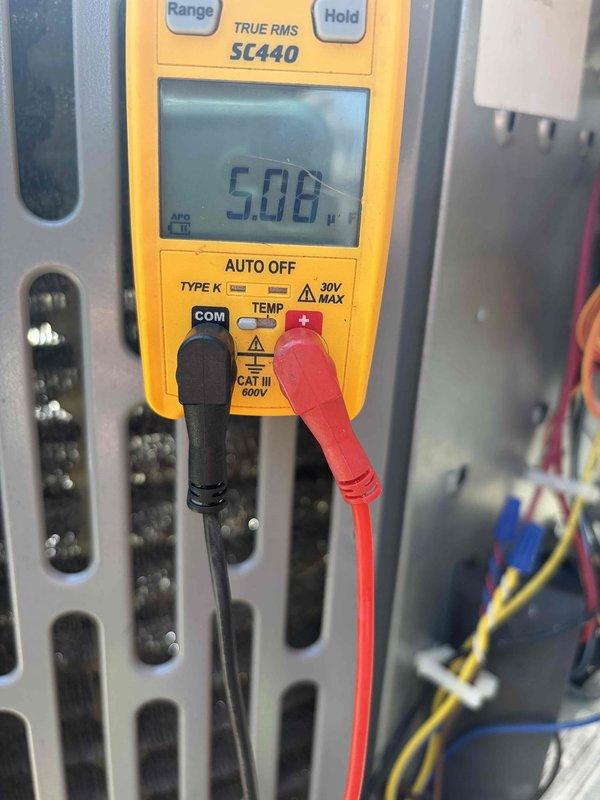 Completed AC club maintenance visit on air handler system. Performed diagnostic testing using digital multimeter, measuring microamp readings on the Emerson control board to verify proper circuit operation. Inspected control board displaying diagnostic code "dl" and checked all wire connections and harness terminations. All electrical connections secure, system control board functioning within normal parameters.