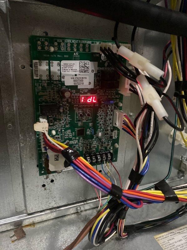 Completed AC club maintenance visit on air handler system. Performed diagnostic testing using digital multimeter, measuring microamp readings on the Emerson control board to verify proper circuit operation. Inspected control board displaying diagnostic code "dl" and checked all wire connections and harness terminations. All electrical connections secure, system control board functioning within normal parameters.