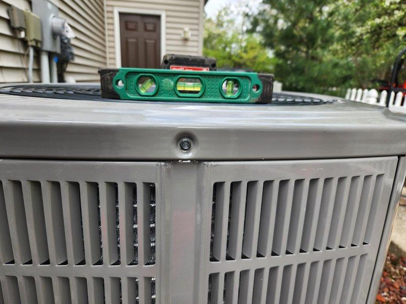 Completed full HVAC system installation including new outdoor condensing unit and associated electrical components. Installed outdoor disconnect box with proper wiring connections and verified level installation of all equipment. Removed and sealed both basement registers on the supply trunk per specifications. All electrical connections properly terminated and secured. System positioned on level pad, equipment leveled and verified operational.