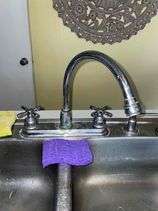 Responded to service call for leaking faucets in both bathroom and kitchen. Inspected vintage three-handle tub/shower valve assembly with chrome cross-handle fixtures and tub spout in bathroom with pink tile surround. Assessed kitchen dual-handle chrome faucet with high-arc spout mounted on stainless steel sink. Identified worn valve seats and deteriorated washers causing drips in both locations. Replaced faulty components, tested water flow and temperature control on all handles, and verified complete leak elimination at both fixtures.