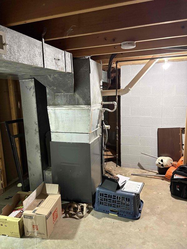 Conducted evening estimate appointment for AC unit replacement. Evaluated existing 5-year-old air conditioning system and associated HVAC infrastructure located in basement area with exposed ductwork and metal furnace unit. Documented current equipment condition through photographs and provided comprehensive replacement quote to homeowner for new cooling system installation.