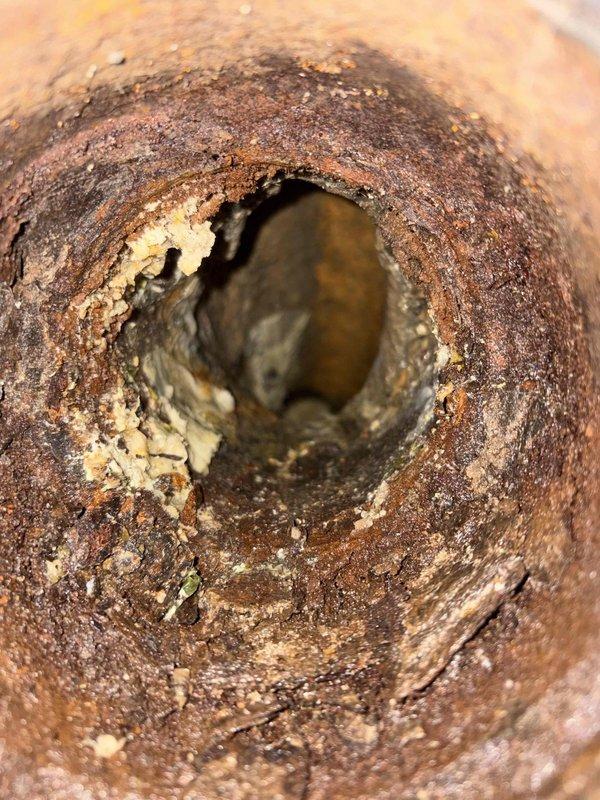 Responded to clogged drain call at 80-year-old residential property. Upon arrival, utilized electronic detection equipment to locate and assess the plumbing obstruction. Investigation revealed severely corroded cast iron drain line with extensive rust buildup and mineral deposits restricting interior pipe diameter. The corrosion had created rough, flaky oxidation layers with calcium scale accumulation throughout the pipe's interior surface, significantly reducing flow capacity and causing the drainage issue. Cleared the immediate blockage and documented the advanced deterioration of the existing drain line for homeowner's awareness of underlying infrastructure condition requiring future replacement consideration.