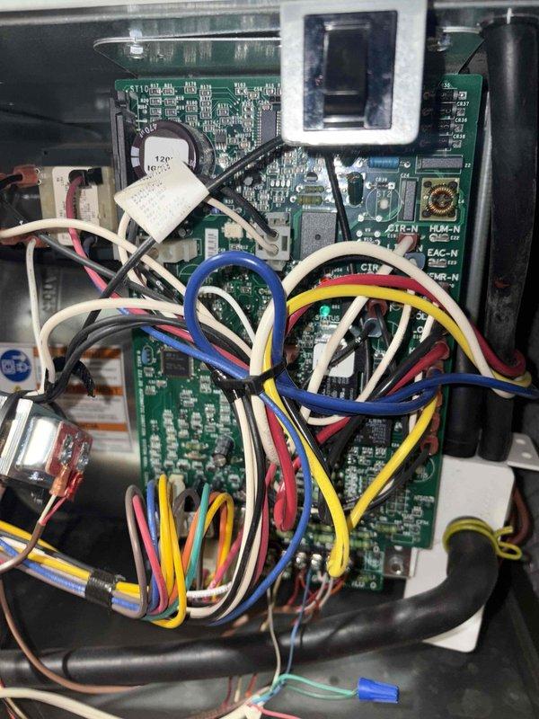 Completed cooling maintenance club visit on air handler system. Performed inspection of control board assembly and electrical components, documenting internal wiring configuration and circuit board condition with coin cell battery intact. Verified exterior disconnect switch operation and condition. All components found in proper working order with no issues identified during routine maintenance inspection.