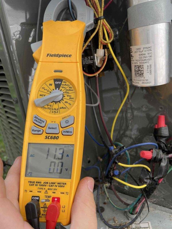Completed prepaid cooling maintenance visit on air handler unit. Performed electrical diagnostics using multimeter, verifying amp draw at 1.3A and checking capacitor operation with all wire connections secure. Measured and recorded indoor air conditions at 54.7°F and 45.05% relative humidity, confirming proper system performance and airflow.
