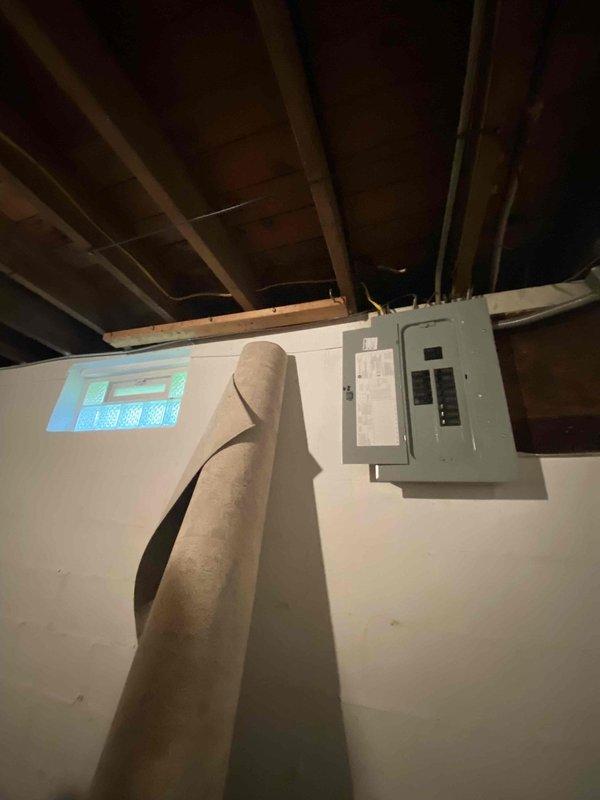 Conducted site assessment for mini split installation to supplement existing baseboard heating system. Customer requires cooling capacity for rooms located on opposite sides of residence. Evaluated electrical panel capacity and available breaker spaces in basement to determine feasibility of supporting two mini split units. Documented current electrical infrastructure including main panel configuration and available circuit capacity. Based on room layout and distance between target areas, recommended dual mini split system installation with separate outdoor condensing units to efficiently serve opposite sides of home.