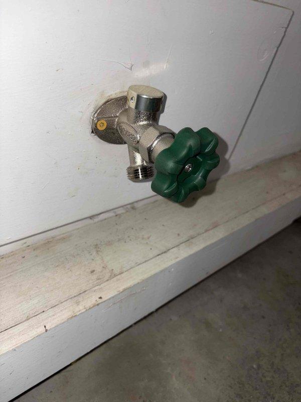 Replaced two outdoor hose bibs that were no longer functioning properly. The first spigot was a freeze-proof wall hydrant with a green handle wheel valve installed at foundation level, and the second was a ceiling-mounted fixture located under an exterior overhang or soffit area. Both fixtures were successfully replaced and tested for proper operation and leak-free performance.