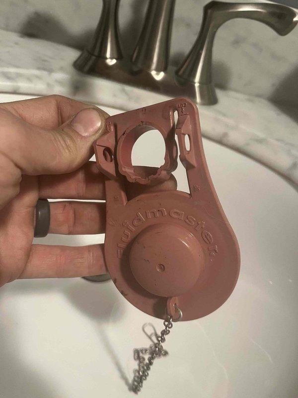 Responded to a running toilet complaint and identified a faulty vacuum breaker assembly. Removed and replaced the defective Woodmaster backflow preventer component, which was causing continuous water flow. Placed collection bucket beneath utility area plumbing connections as a precautionary measure during diagnostics and repair, then tested system to confirm proper operation and water shutoff functionality.