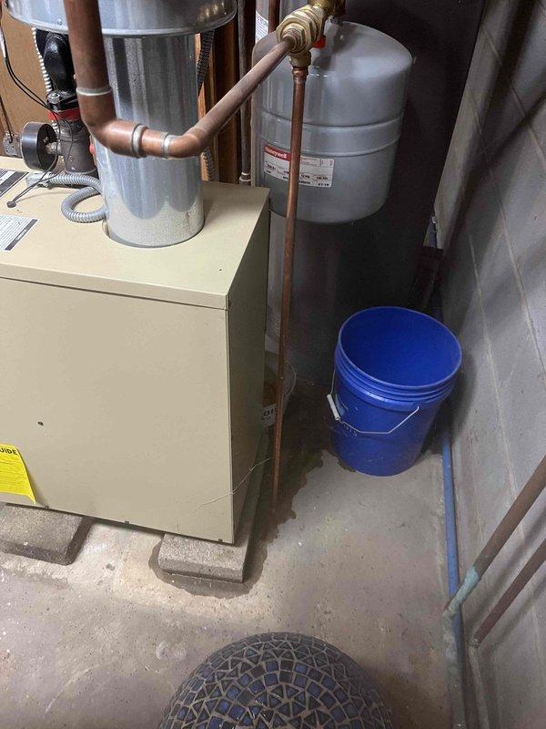 Responded to a running toilet complaint and identified a faulty vacuum breaker assembly. Removed and replaced the defective Woodmaster backflow preventer component, which was causing continuous water flow. Placed collection bucket beneath utility area plumbing connections as a precautionary measure during diagnostics and repair, then tested system to confirm proper operation and water shutoff functionality.