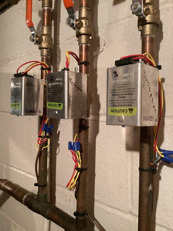 Completed boiler maintenance club member visit. Inspected and serviced hydronic heating zone control system including three Honeywell zone valves with associated copper piping, brass fittings, and control wiring. Verified proper operation of all zone controllers, checked electrical connections, and confirmed system functionality. All equipment found to be operating within normal parameters.