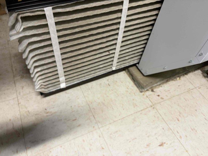 Performed cooling maintenance on air handler unit as part of club membership visit. Addressed thermostat screen malfunction, inspected heavily soiled air filter showing significant dust and debris accumulation, and conducted electrical diagnostics using digital multimeter to verify system voltage and amperage readings. Filter replacement recommended due to excessive particulate buildup affecting airflow and system efficiency.