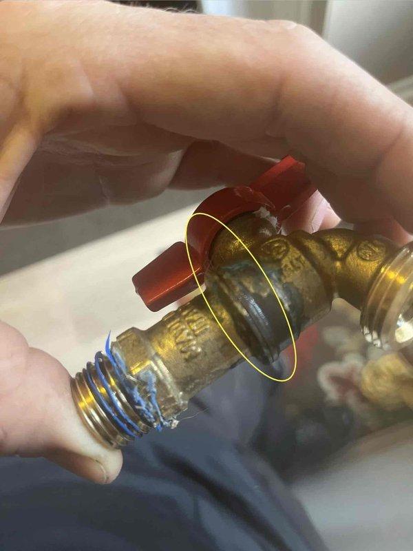 Responded to service call for leaking ball valve on kitchen water supply line. Upon inspection, identified leak at threaded connection on newly installed brass ball valve with red handle lever. Removed defective valve, cleaned threaded connections, applied fresh thread seal tape, and reinstalled replacement valve. Tested system under full pressure to verify proper seal and confirm no additional leaks present.