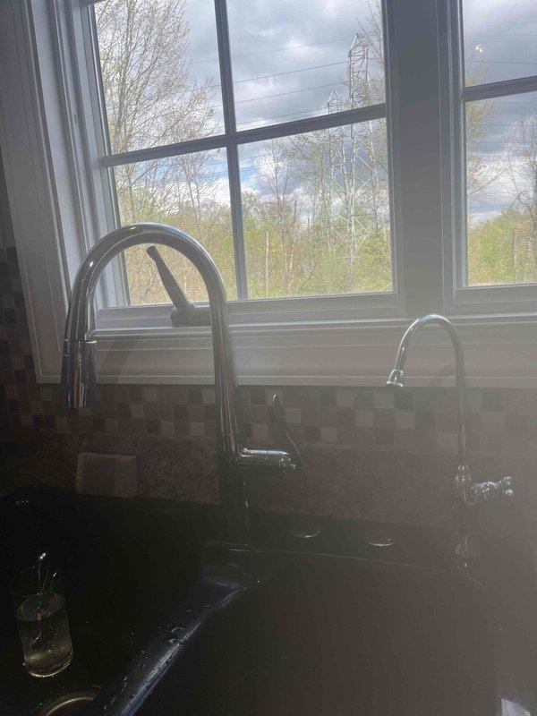 Responded to service call for leaking ball valve on kitchen water supply line. Upon inspection, identified leak at threaded connection on newly installed brass ball valve with red handle lever. Removed defective valve, cleaned threaded connections, applied fresh thread seal tape, and reinstalled replacement valve. Tested system under full pressure to verify proper seal and confirm no additional leaks present.
