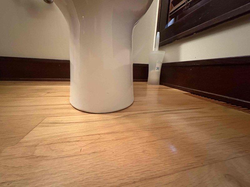 Installed customer-supplied toilet in residential bathroom, including securing the fixture to the floor flange and connecting the braided stainless steel water supply line to the wall-mounted shut-off valve. Tested the installation to ensure proper operation and verified no leaks were present.
