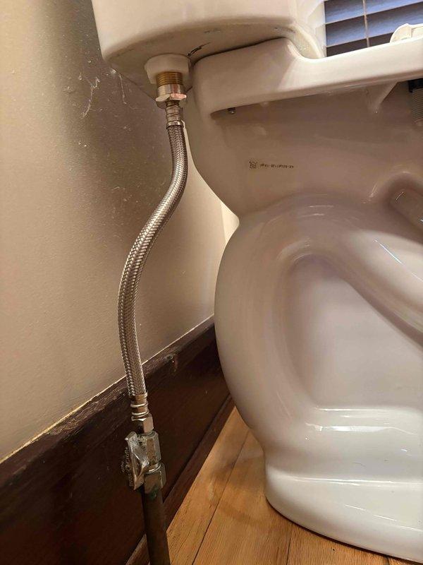 Installed customer-supplied toilet in residential bathroom, including securing the fixture to the floor flange and connecting the braided stainless steel water supply line to the wall-mounted shut-off valve. Tested the installation to ensure proper operation and verified no leaks were present.
