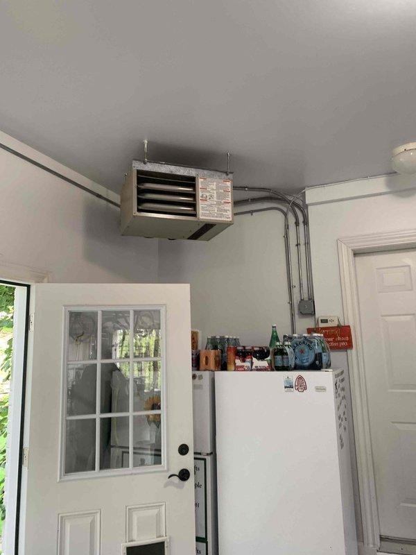 Responded to no heating/cooling complaint on Mitsubishi mini split system where indoor fan was operational but compressor failed to engage. Performed diagnostic evaluation, documented equipment location and installation in garage utility space, and captured site conditions for service records.