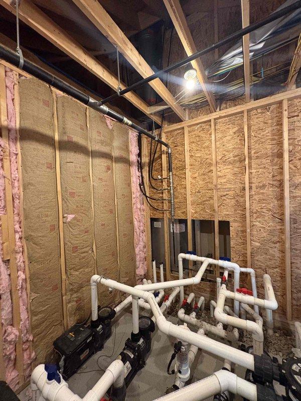 Responded to service call for 5-year-old Black and Decker tankless water heater with no hot water production since installation. Upon arrival, conducted comprehensive diagnostic assessment of the unit and associated utility connections. Inspected the natural gas supply line and meter installation at the exterior of the residence, noting visible corrosion and rust on gas line fittings and valve connections that could potentially affect gas flow to the appliance. Examined the basement mechanical room installation, including the complex PVC piping configuration and water distribution system connected to the tankless unit. Performed gas line pressure testing and verified proper gas supply availability at the meter. Identified issues with gas delivery system requiring further evaluation to restore hot water functionality to the previously non-operational tankless water heater system.