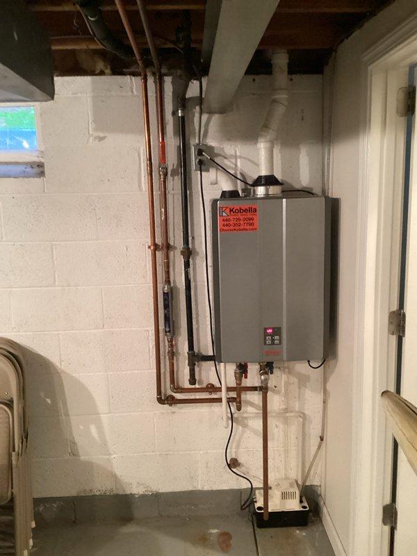 Completed plumbing maintenance membership visit including comprehensive inspection of residential plumbing systems. Performed visual assessment of wall-mounted tankless water heater unit, examining copper supply lines, PVC venting system, condensate drain connections, and all associated fittings and valves for proper operation and potential issues. Customer was informed that tankless water heater flushing service is not included under the standard membership coverage.