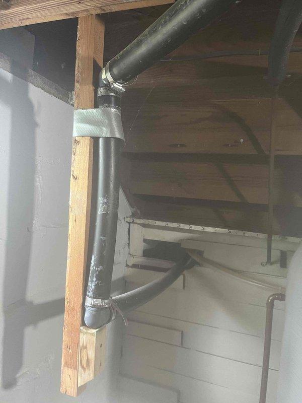 Responded to water leak complaint originating from bathtub drain assembly. Upon inspection, identified failed drain gasket and deteriorated plumber's putty causing water to seep past the drain connection during tub use. Accessed the drain assembly from below through basement ceiling, requiring work in confined space among existing plumbing and HVAC infrastructure.

Removed existing drain fitting and thoroughly cleaned all mating surfaces of old sealant and debris. Installed new drain assembly with fresh plumber's putty and rubber gasket, ensuring proper compression and seal. Secured all connections with appropriate torque to prevent future leaks while avoiding over-tightening that could crack the tub surface. Applied PVC pipe support clamps to adjacent drainage lines to eliminate stress on connections and prevent future movement-related failures.

Tested repair by filling tub and releasing water multiple times while monitoring drain connection from below for any signs of moisture. Conf
