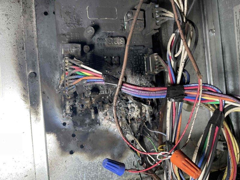 Responded to no heat call on furnace system. Upon arrival, found furnace and humidistat in off position with no power to units. Inspection of electrical control panel revealed catastrophic failure due to severe electrical fault resulting in extensive fire damage to control board, wiring harness, and panel enclosure. Multiple wire connections showed melted insulation, charring, and heat exposure throughout the affected area. Control relay and associated components exhibited burn damage with heavy soot accumulation on metal surfaces and wire bundles. System deemed unsafe for operation due to compromised electrical integrity and fire hazard. Recommended complete replacement of furnace unit given extent of internal damage to electrical components and potential compromise to other system elements not immediately visible.