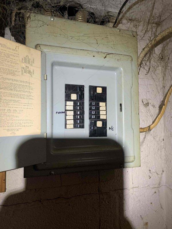 Responded to no heat call for 38-year-old furnace with no airflow. Upon arrival, inspected electrical panel and furnace system in basement utility area, documenting existing conditions including aged infrastructure with extensive dust and cobweb accumulation throughout mechanical space. Assessed system operability and provided customer with recommendations given the advanced age of the equipment beyond its expected service life.