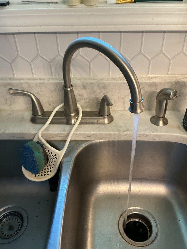 Completed plumbing membership maintenance visit. Inspected kitchen sink plumbing system including faucet operation, drainage, and under-sink supply lines and connections. Customer expressed interest in camera inspection for slow-draining garage floor drain for future service consideration.