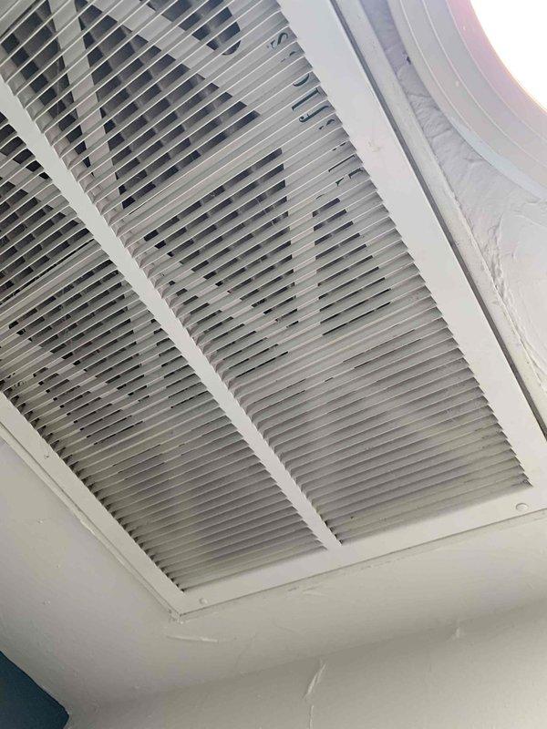 Completed routine cooling maintenance club member visit on attic-mounted HVAC system. Accessed unit via attic entry, performed standard maintenance inspection including examination of return air grille, equipment panel, and system components. Documented equipment condition with photos showing ceiling-mounted return vent and unit warning labels for service records.
