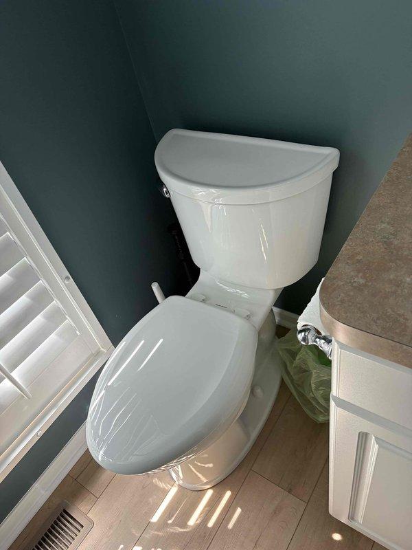 Responded to service call for two toilets requiring repair. First toilet diagnosed with slow flushing issue and corroded mounting bolt at base. Second toilet found with faulty flush valve that required manual adjustment to prevent continuous running. Completed necessary repairs to restore proper function to both fixtures. Installation of new components visible in documentation photos showing updated plumbing connections and supply lines.
