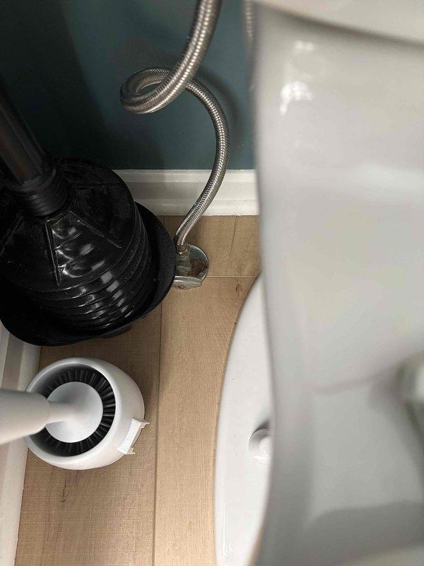 Responded to service call for two toilets requiring repair. First toilet diagnosed with slow flushing issue and corroded mounting bolt at base. Second toilet found with faulty flush valve that required manual adjustment to prevent continuous running. Completed necessary repairs to restore proper function to both fixtures. Installation of new components visible in documentation photos showing updated plumbing connections and supply lines.