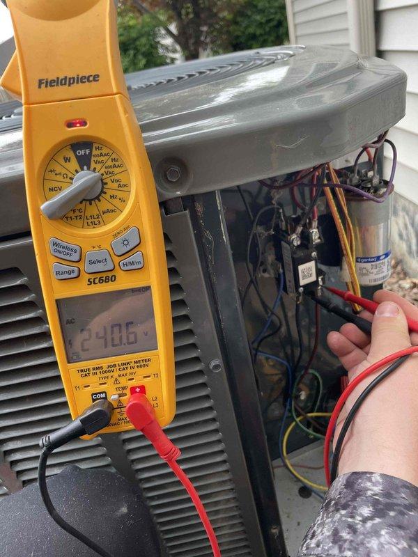 Completed comprehensive AC tune-up on five-year-old air conditioning system with no reported issues. Performed electrical diagnostics using multimeter to verify voltage readings at 240.6V, tested capacitor functionality, and inspected all wire connections and terminals within the condensing unit. All components operating within normal parameters; system maintenance completed successfully.