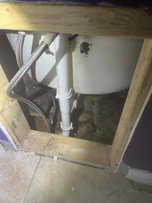 Responded to service call for bathtub drainage issue. Upon investigation, accessed drain assembly through floor access panel and inspected drainage system components including PVC drain line and associated plumbing connections. Diagnosed obstruction preventing proper drainage from tub. Cleared blockage and verified proper water flow through drain system. Also provided estimate for toilet resetting and sink repair work as requested.