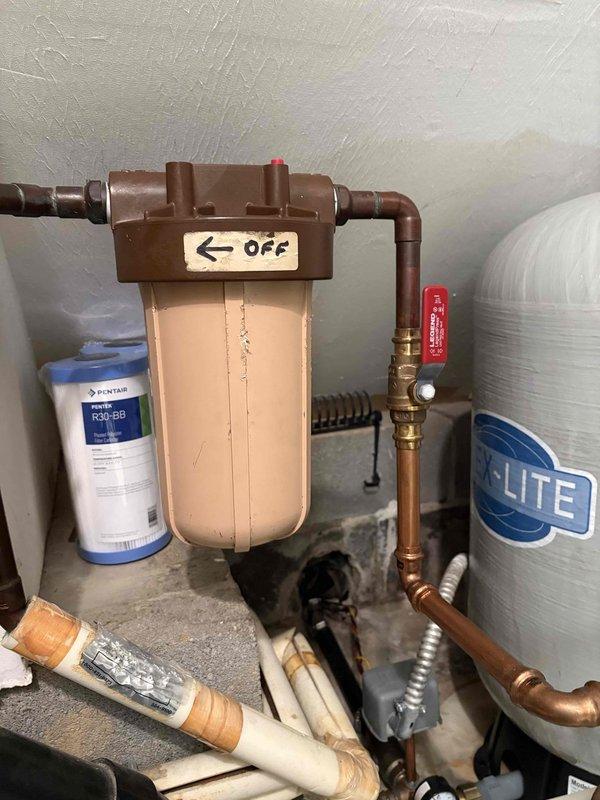 Delivered and loaded two bags of salt into the water softener system to maintain proper operation. Performed comprehensive system inspection of the residential water treatment equipment, including the main water filtration unit with Pentair filter cartridge, copper piping connections, ball valves, and water softener tank. Verified proper functioning of all components, checked valve operations, and confirmed adequate salt levels for continued water conditioning performance.