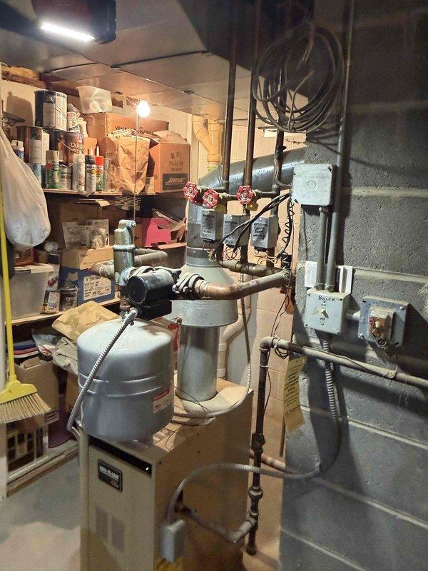 Responded to service call for reported boiler leak in residential heating system. Upon inspection, identified active leak at aged brass valve fitting on primary heating loop with visible corrosion and deterioration on copper piping connections. Documented condition of existing mechanical components showing advanced oxidation and patina buildup indicative of long-term moisture exposure. System requires valve replacement and potential repiping of affected sections to restore proper operation and prevent further water damage.