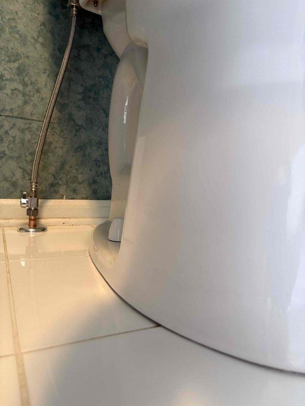 Returned to property to complete plumbing work previously sold. Removed and reset toilet, replacing wax ring seal and addressing previous water damage evident on terracotta tile flooring around flange area. Inspected toilet flange for proper alignment and secure mounting, confirmed bolts and hardware properly seated. Verified handheld shower fixture installation and connections in bathroom with freestanding tub, ensuring all chrome fixtures were leak-free and functioning correctly. All plumbing components tested and left in proper working order.