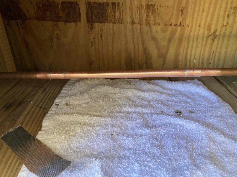 Responded to water leak caused by failed SharkBite fitting that resulted in pipe failure. Removed the defective push-fit connection and properly sweated copper pipe using traditional soldering methods to create a permanent, leak-free joint. Customer provided replacement materials for the repair. Accessed plumbing through crawl space area where copper supply line runs along floor joists above insulation layer. Successfully restored water system integrity and tested connections to ensure proper seal with no active leaks.