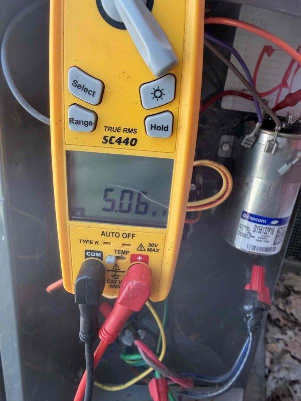 Completed cooling maintenance club visit on air handler system. Performed electrical diagnostics using digital multimeter, measuring amperage draw at 54.2A and verifying voltage readings at 5.05V. Inspected and tested capacitor connections, confirming proper wire terminations and electrical continuity throughout the system to ensure optimal performance.