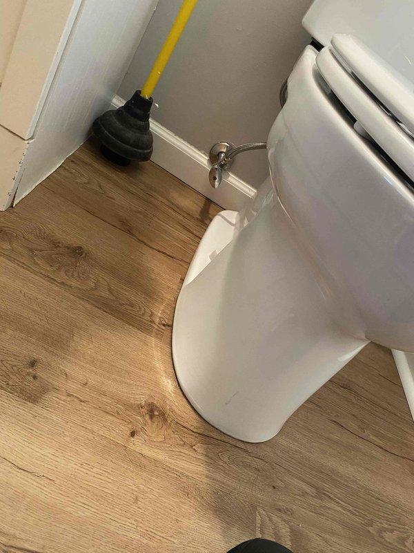 Responded to service call for loose toilet handle. Inspected flush mechanism and tightened mounting nut securing handle to tank. Verified proper operation of flush lever and confirmed handle is now secure with no excessive play or movement.
