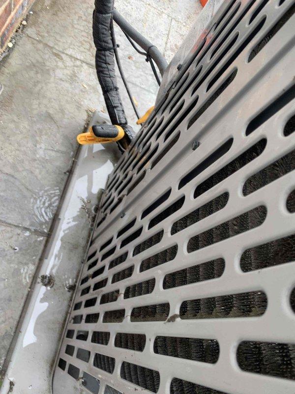 Completed comprehensive AC maintenance visit including inspection of air handler unit and control system. Examined air handler with perforated grille casing, confirmed proper airflow through filter media, and inspected refrigerant lines with foam insulation. Verified control board functionality with illuminated status LED indicating normal operation. System operating within normal parameters with all components functioning properly.